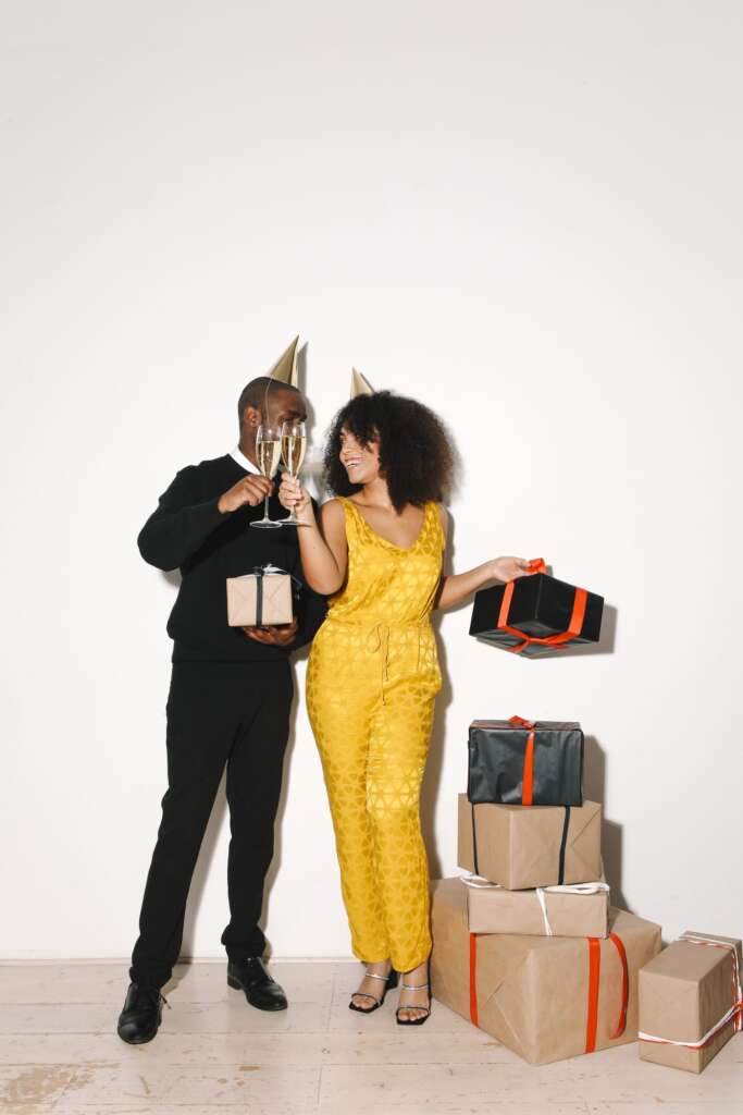 Couple celebrating anniversary with champagne and gifts