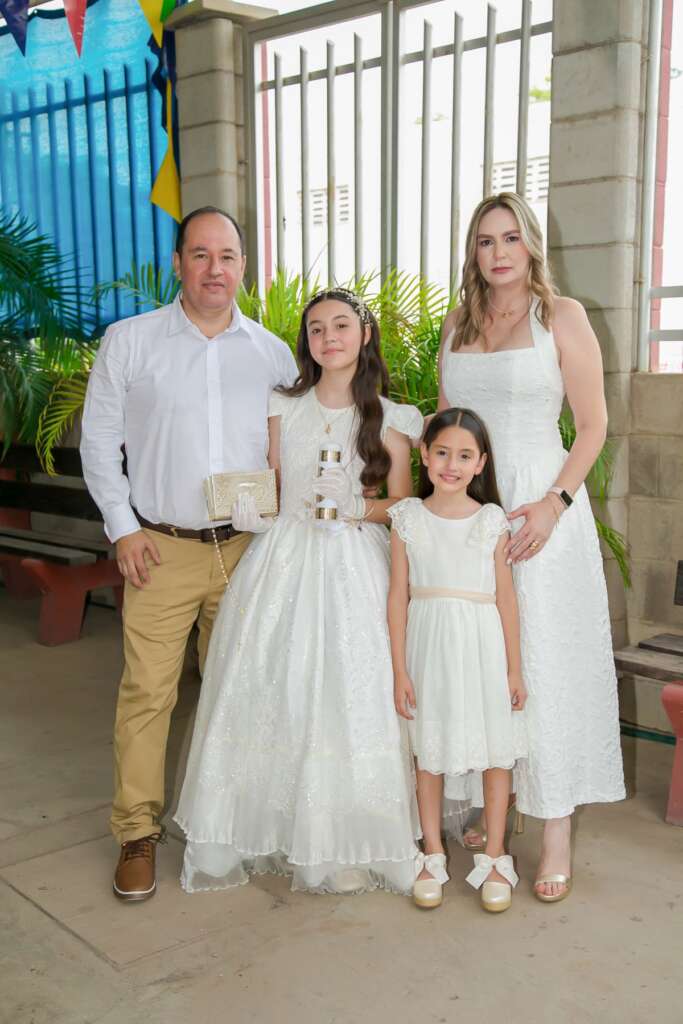 Family dressed in white for a first communion