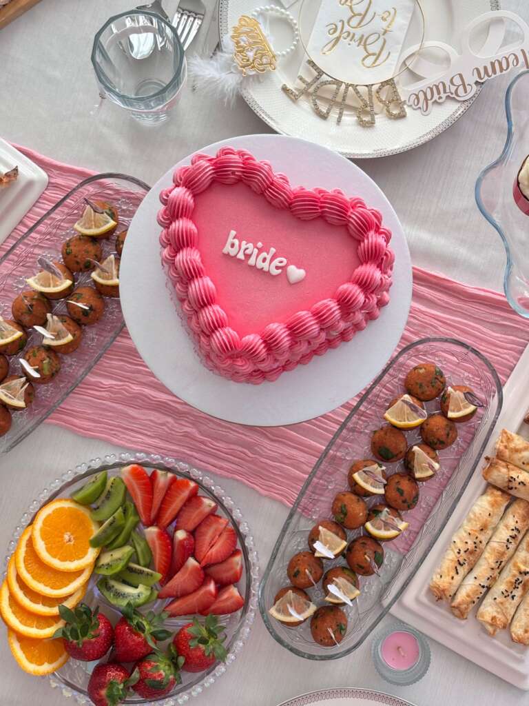Pink heart-shaped bride cake at a bridal shower