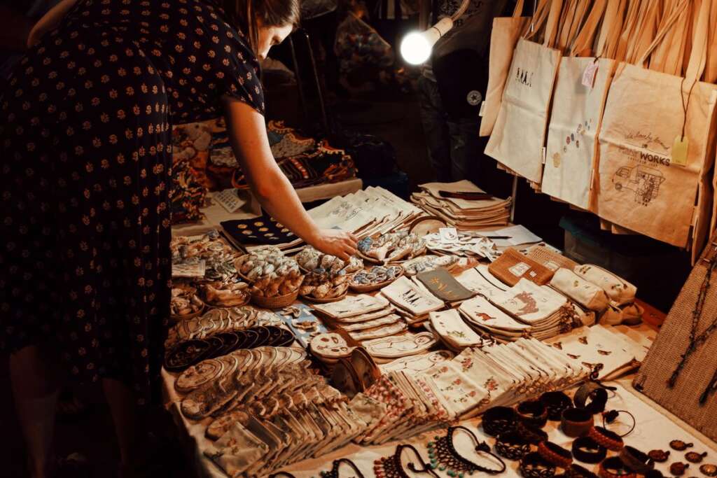 Shoppers browsing a vendor stall at a market
