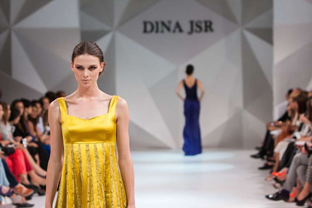 Models walking the runway before a seated audience
